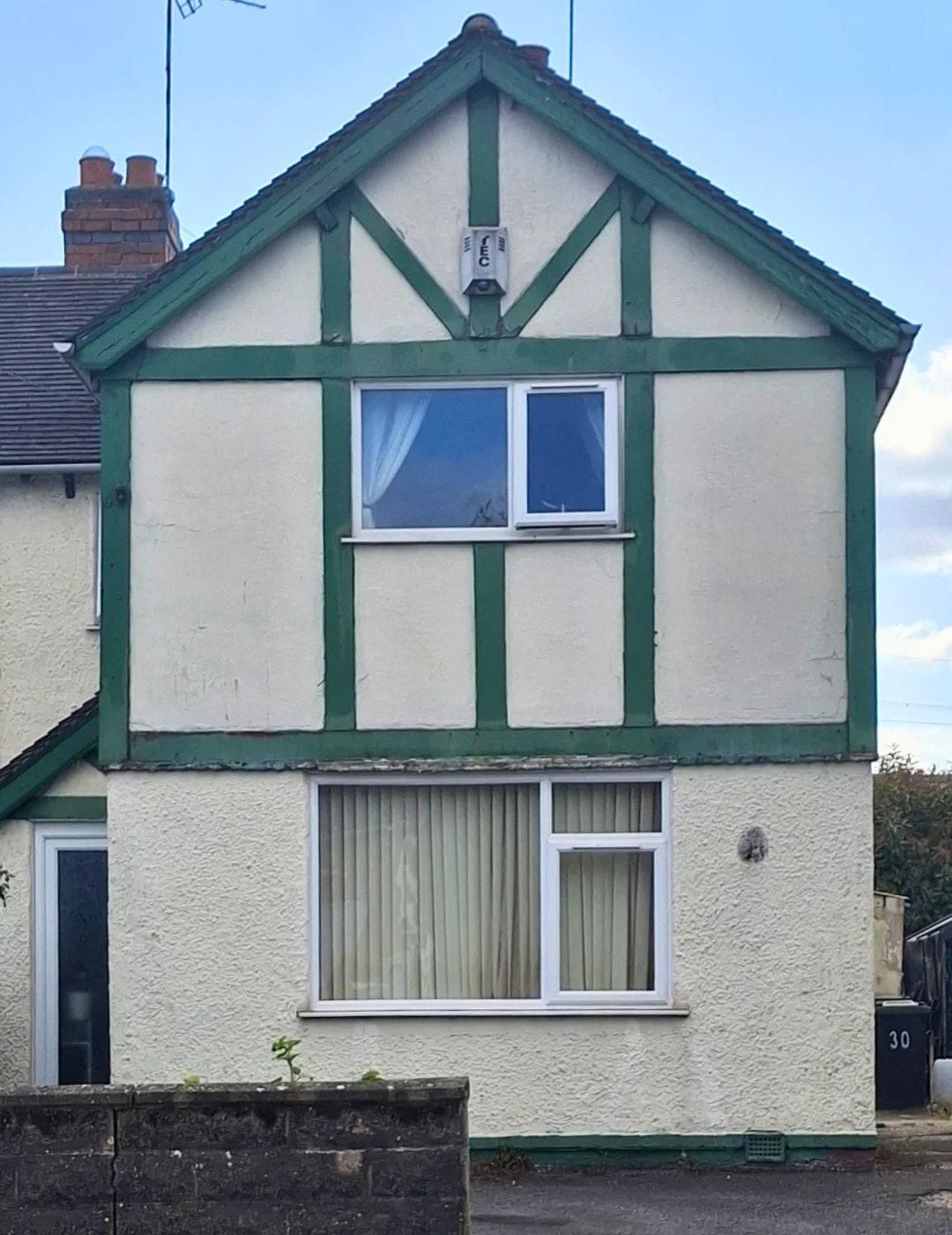 Mock-Tudor semi-detached gable in Derby with dated green timber detailing before render by PD Rendering